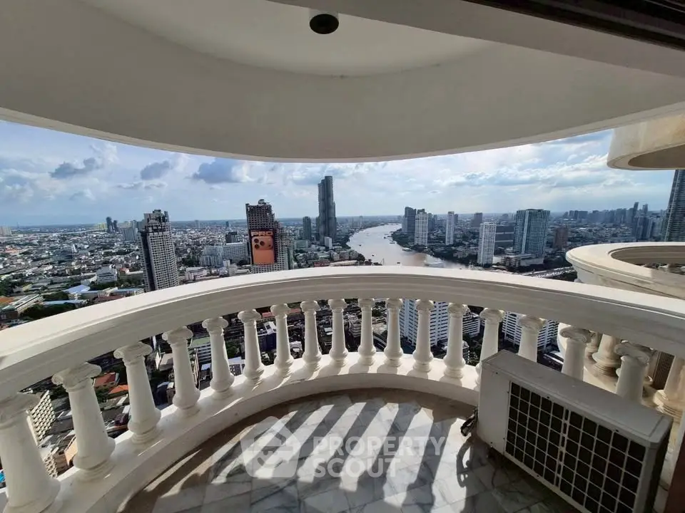 Stunning cityscape view from a high-rise balcony with river and skyline panorama.