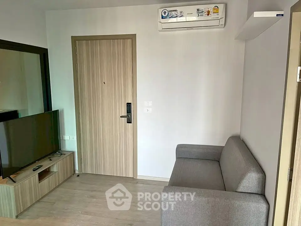 Modern living room with sleek furniture and air conditioning in a stylish apartment.