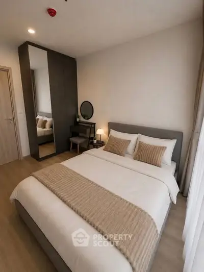 Modern bedroom with cozy decor and stylish furniture in a contemporary apartment.
