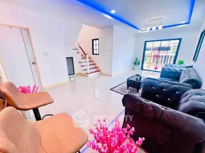 Modern living room with stylish decor and natural light, featuring plush sofas and elegant lighting.