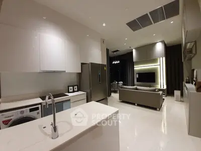 Modern open layout kitchen and living room with sleek design and appliances