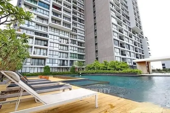 Luxurious condominium with poolside view and modern architecture.