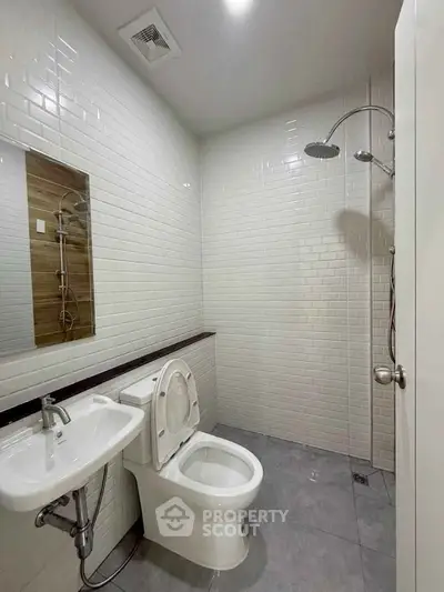 Modern bathroom with sleek white tiles and contemporary fixtures
