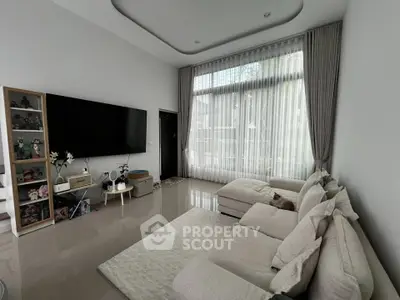 Spacious modern living room with large windows and elegant decor
