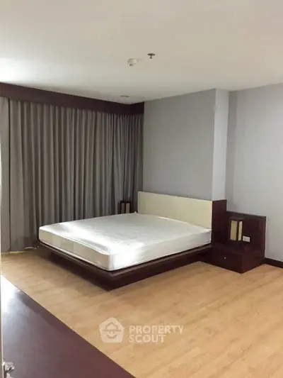 Spacious bedroom with modern design and wooden flooring