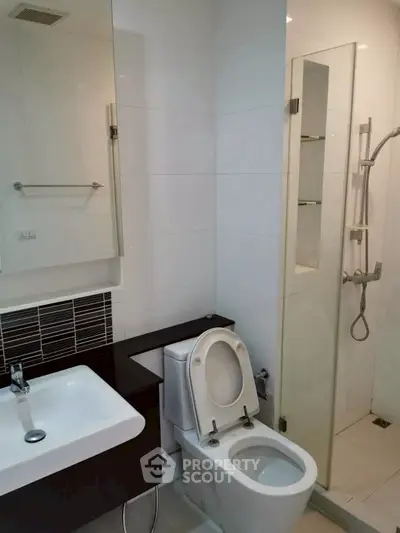 Modern bathroom with sleek fixtures and glass shower enclosure