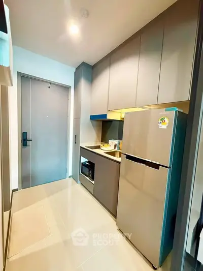 Modern kitchen with sleek cabinetry, stainless steel appliances, and ample storage space.