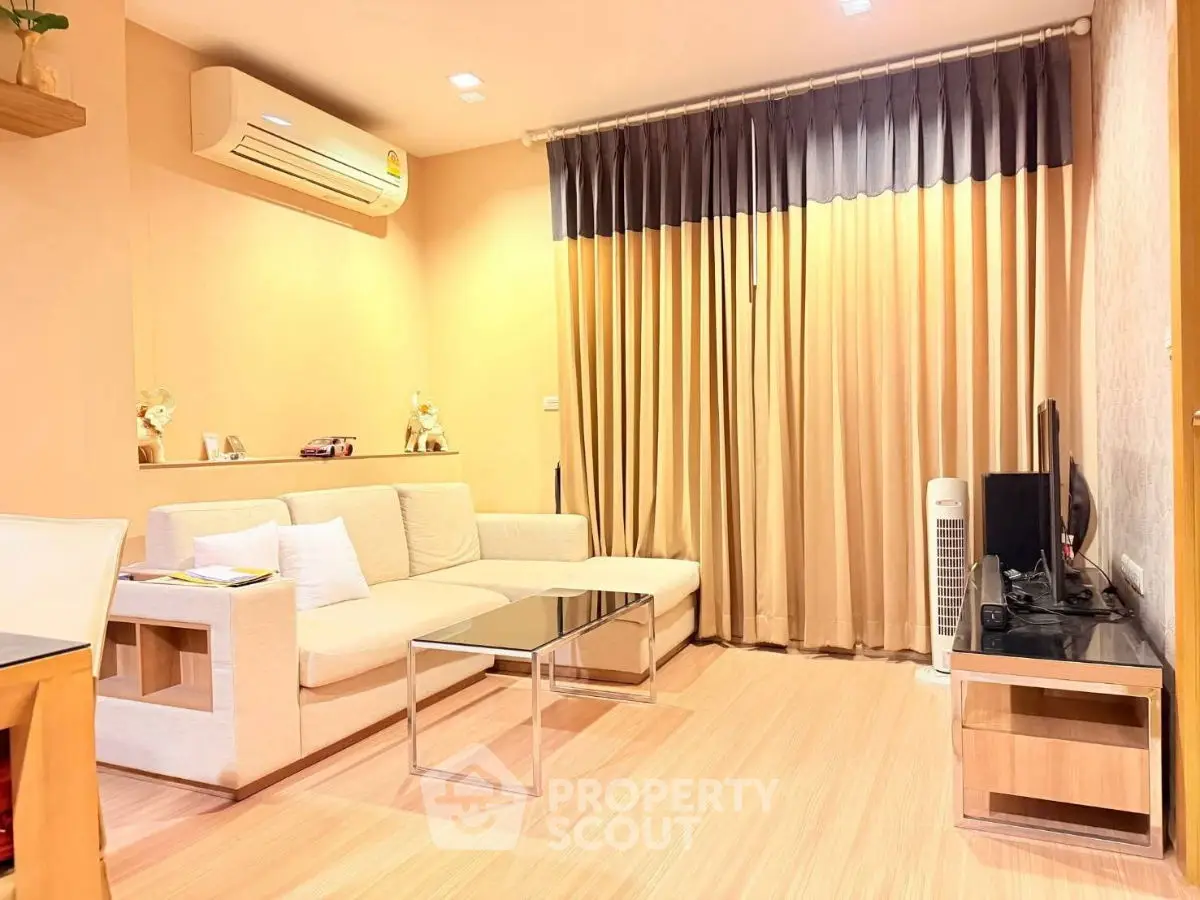 Modern living room with cozy sofa, air conditioning, and stylish decor