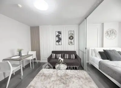 Modern living room with cozy decor and stylish furniture in a compact apartment setting.