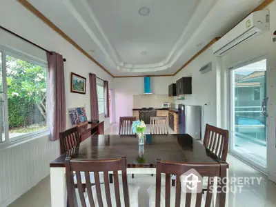 Spacious dining area with modern kitchen and garden view