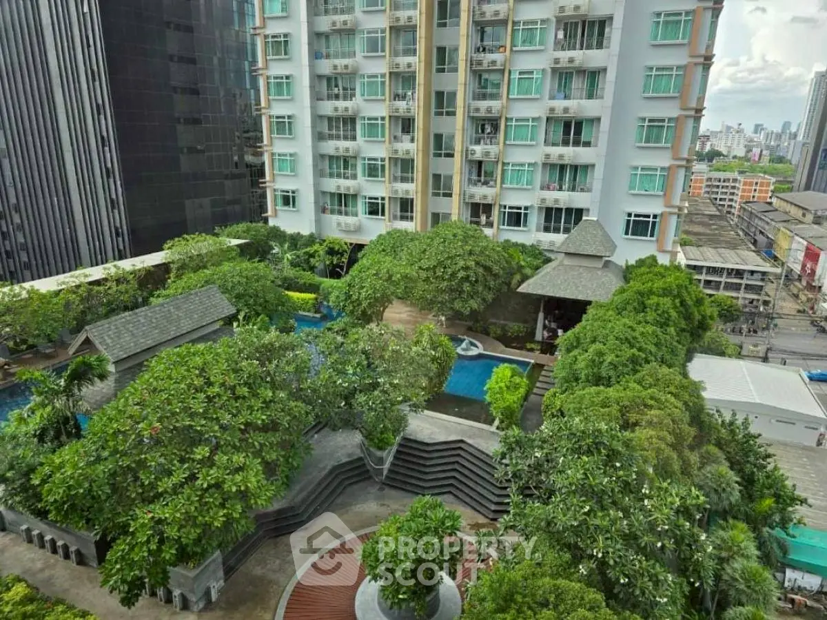 Luxurious urban condominium with lush garden and pool view in prime city location.