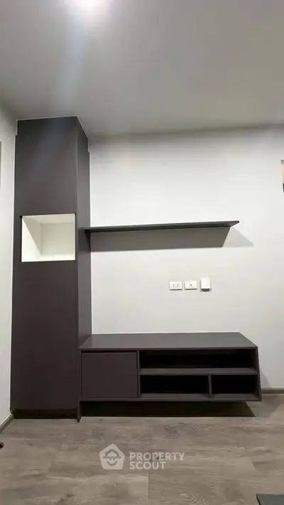 Modern living room with sleek built-in shelving and storage unit, perfect for stylish organization.