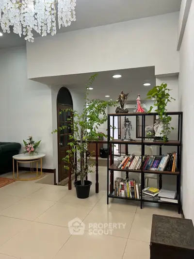 Spacious living room with elegant decor and indoor plants, perfect for relaxation and entertainment.