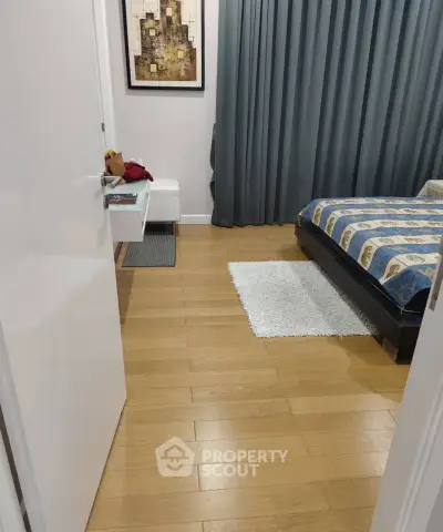 Cozy bedroom with wooden flooring and stylish decor