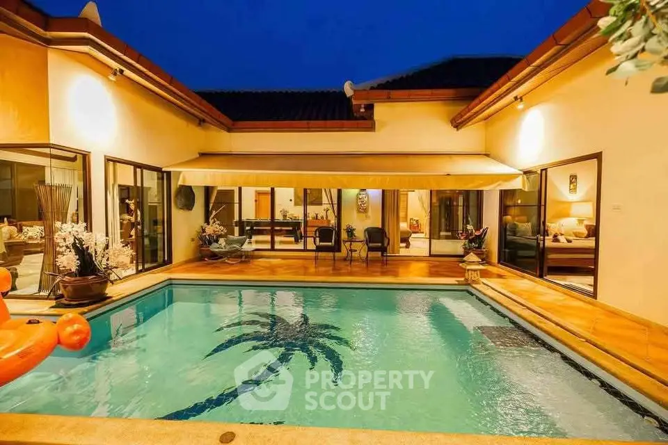 Luxurious villa with private pool and elegant outdoor seating area at dusk.