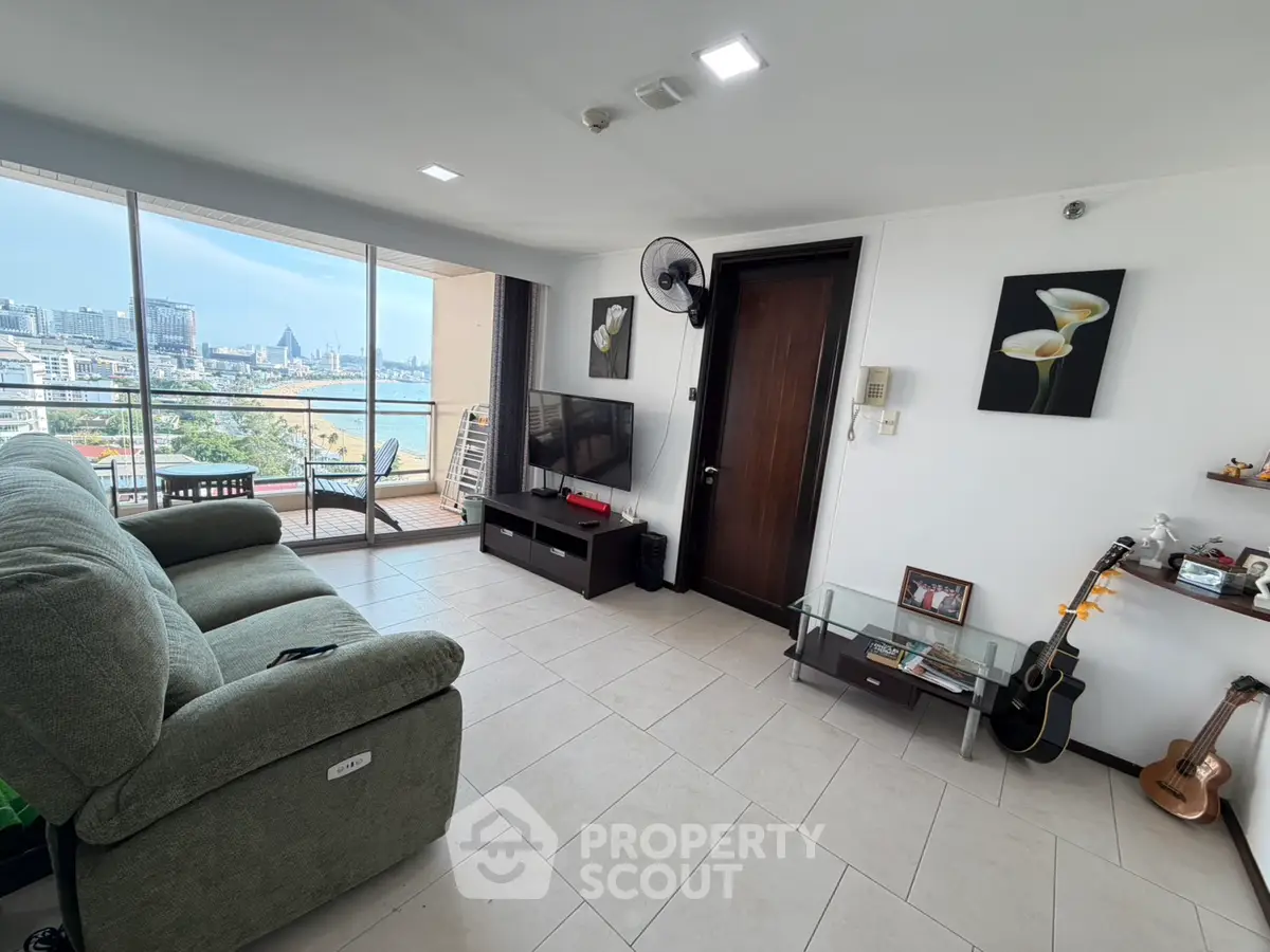 Spacious living room with city view and balcony access in modern apartment