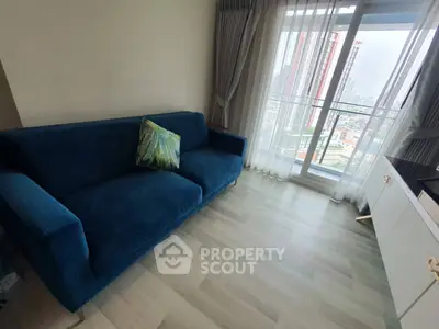 Modern living room with blue sofa and city view from large window