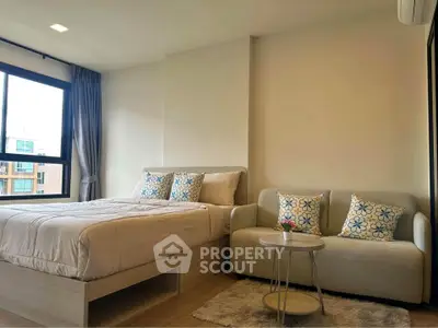 Modern bedroom with cozy sofa and stylish decor in a bright apartment