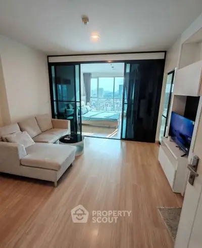 Modern living room with city view and stylish furniture in a high-rise apartment.