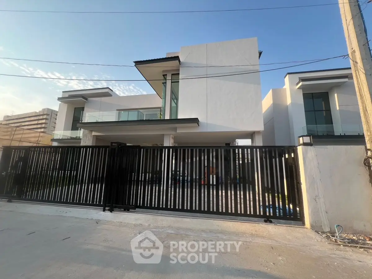 Modern luxury house with sleek design and gated entrance, perfect for upscale living.