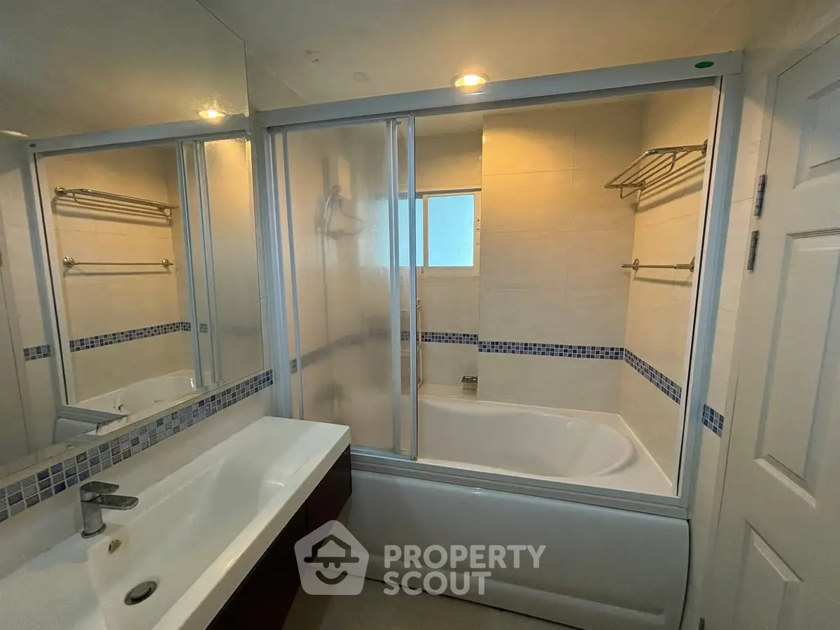 Modern bathroom with bathtub and sleek fixtures in a stylish real estate property.