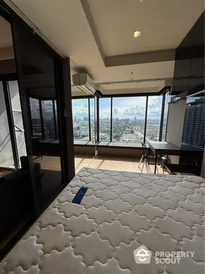 Modern bedroom with stunning city view and large windows