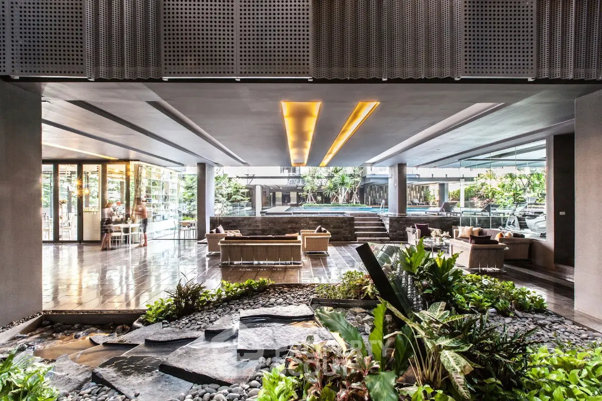 Luxurious open-air lobby with modern design and lush greenery