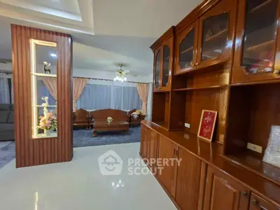 Spacious living room with elegant wooden cabinetry and cozy seating area.