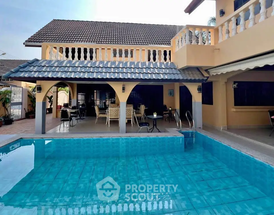 Luxurious villa with spacious poolside patio and elegant architecture