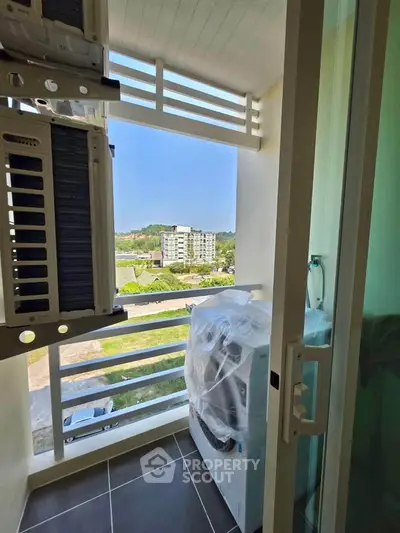 Charming balcony with scenic view and modern appliances, perfect for urban living.