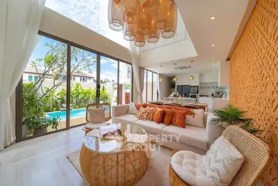 Luxurious living room with pool view and elegant decor in modern villa
