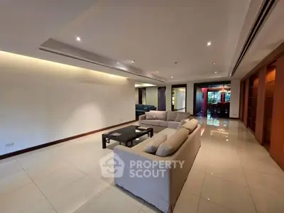 Spacious modern living room with elegant lighting and stylish furniture.