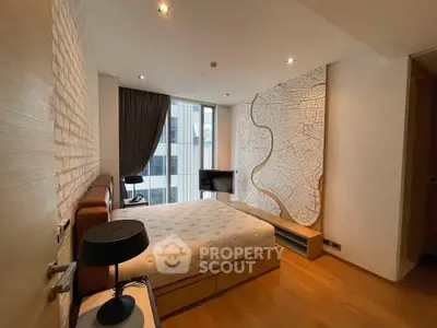 Modern bedroom with stylish decor and large window offering city views