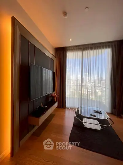 Modern living room with large window and city view, featuring sleek TV setup and stylish coffee table.