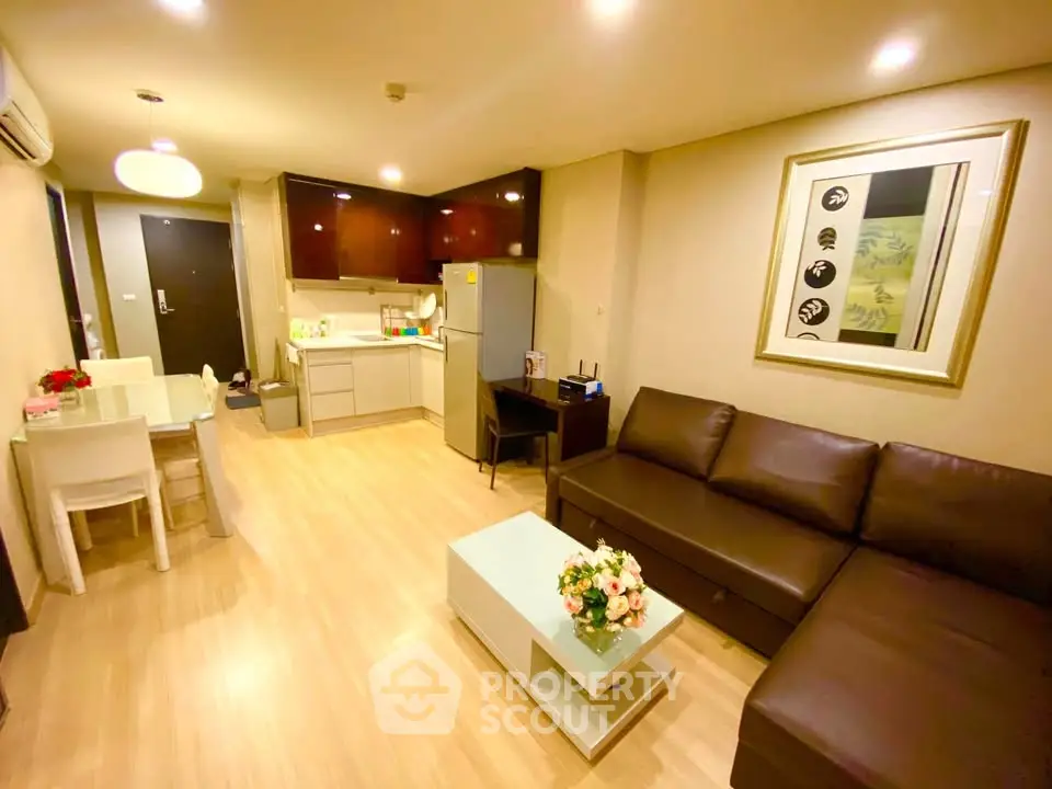 Modern living room with open kitchen and stylish decor in a cozy apartment.