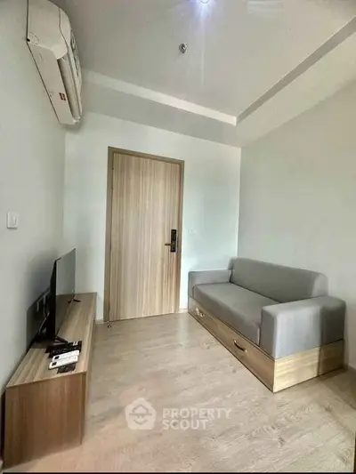 Modern living room with sleek furniture and air conditioning, perfect for cozy living.