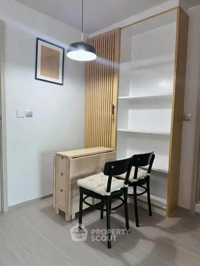 Modern study area with sleek shelving and cozy seating in a minimalist design.
