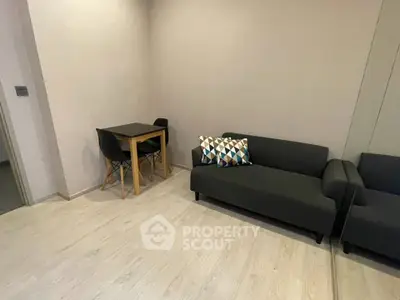 Modern living room with sleek black sofa and stylish dining table set