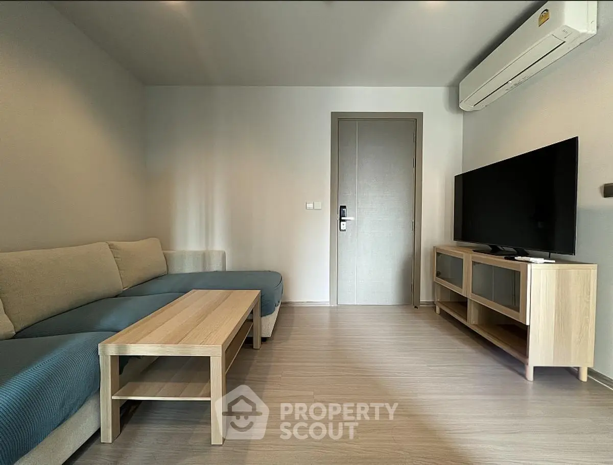 Modern living room with sleek furniture and air conditioning, perfect for comfort and relaxation.