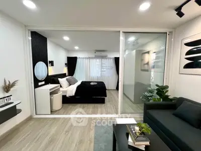 Modern studio apartment with stylish decor and open layout, featuring a cozy bedroom and chic living area.