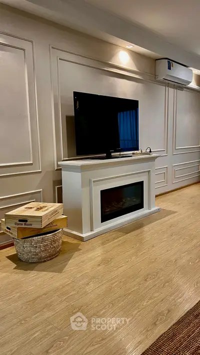 Elegant living room with modern TV stand and air conditioning, featuring stylish wood flooring.