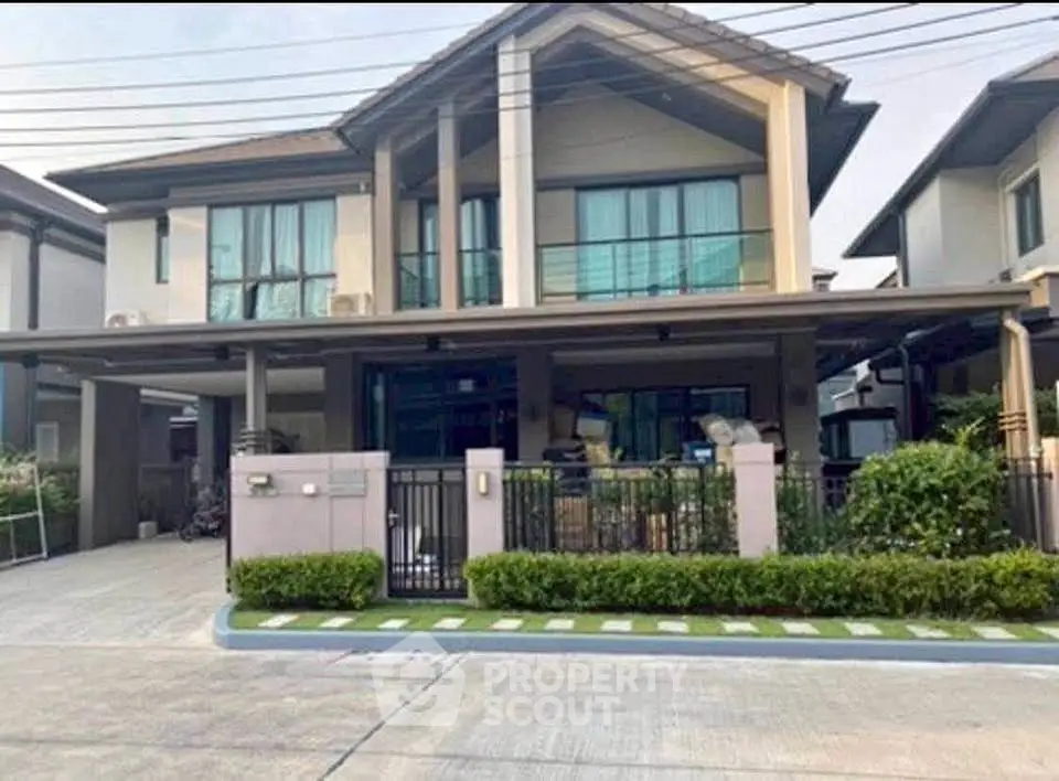 Modern two-story house with spacious driveway and landscaped garden