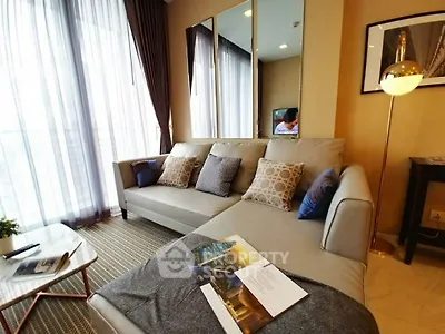 Modern living room with stylish decor and large windows for natural light.