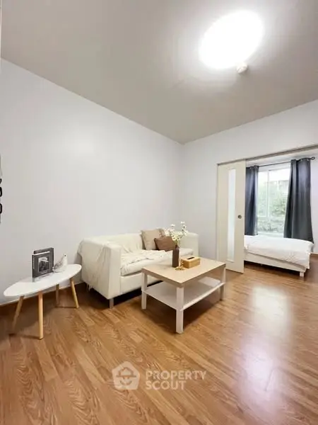 Spacious living room with cozy sofa and natural light