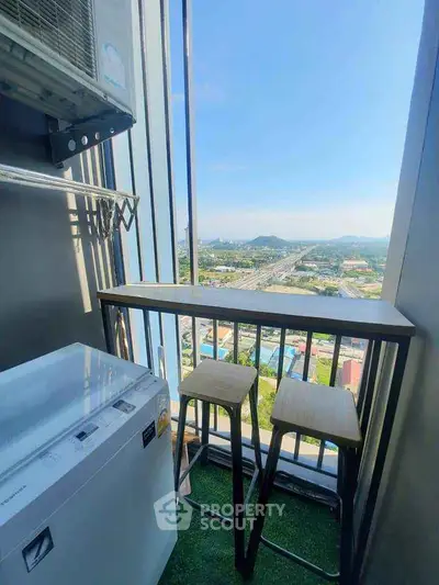 Charming balcony with stunning city view and cozy seating area