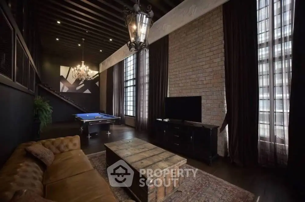 Luxurious living room with pool table and elegant decor, perfect for entertainment.