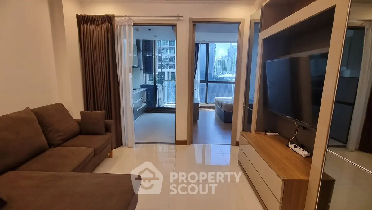 Modern living room with sleek design and city view from balcony