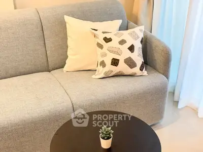 Cozy living room with modern gray sofa and stylish decor
