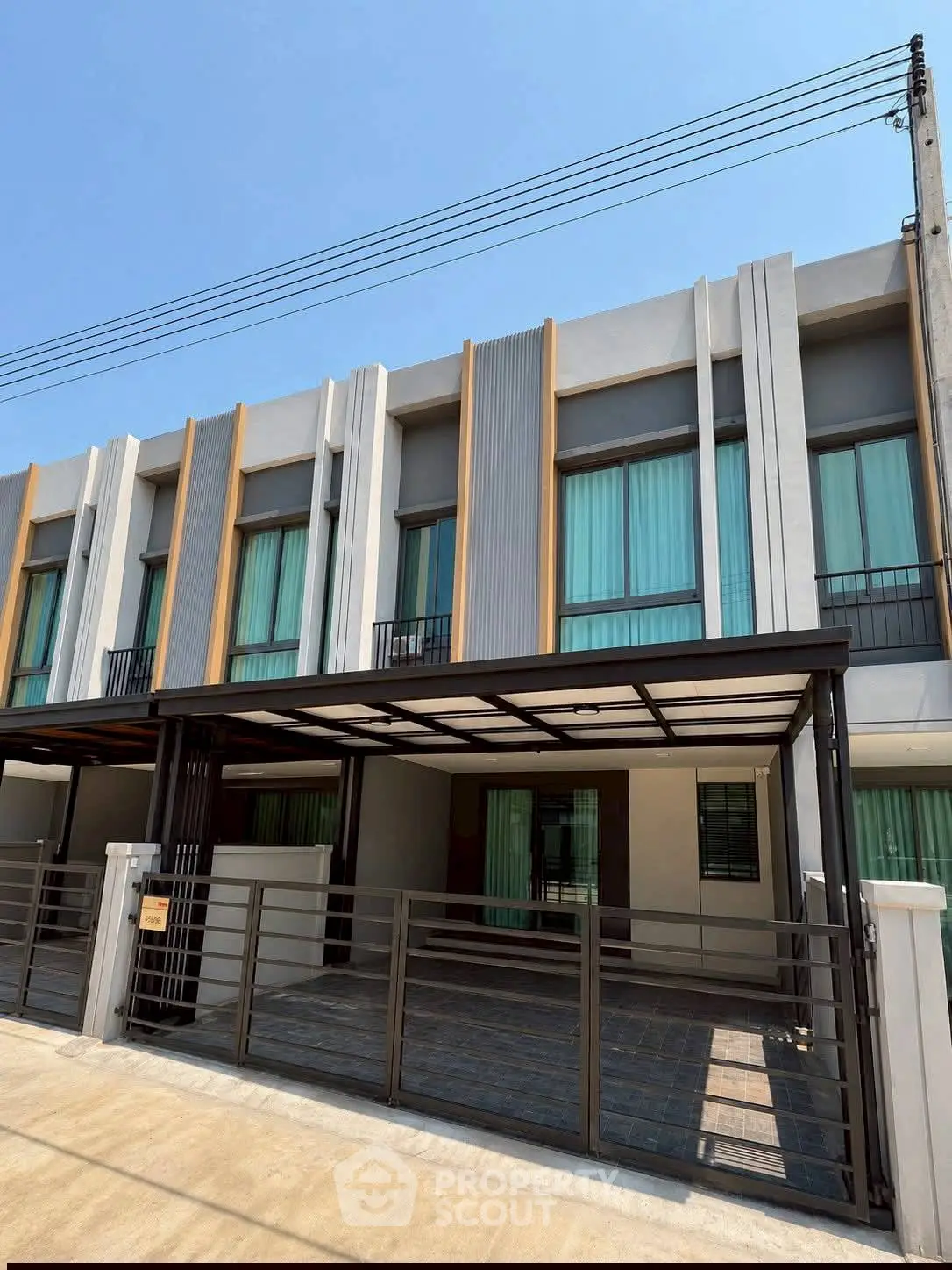 Modern townhouse exterior with sleek design and spacious parking area