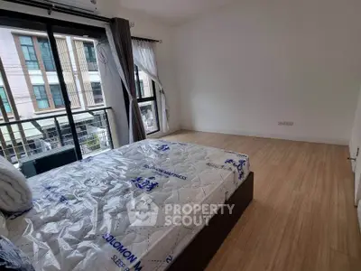Spacious bedroom with large windows and modern design in a prime location.